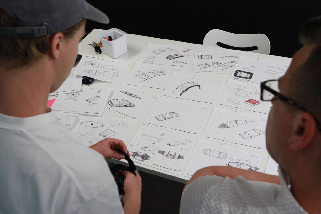 Cortex designers looking over concept sketches