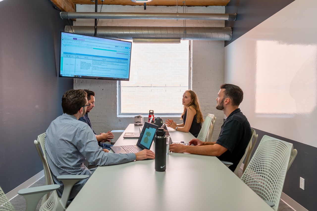 Team members discussing medical device project management